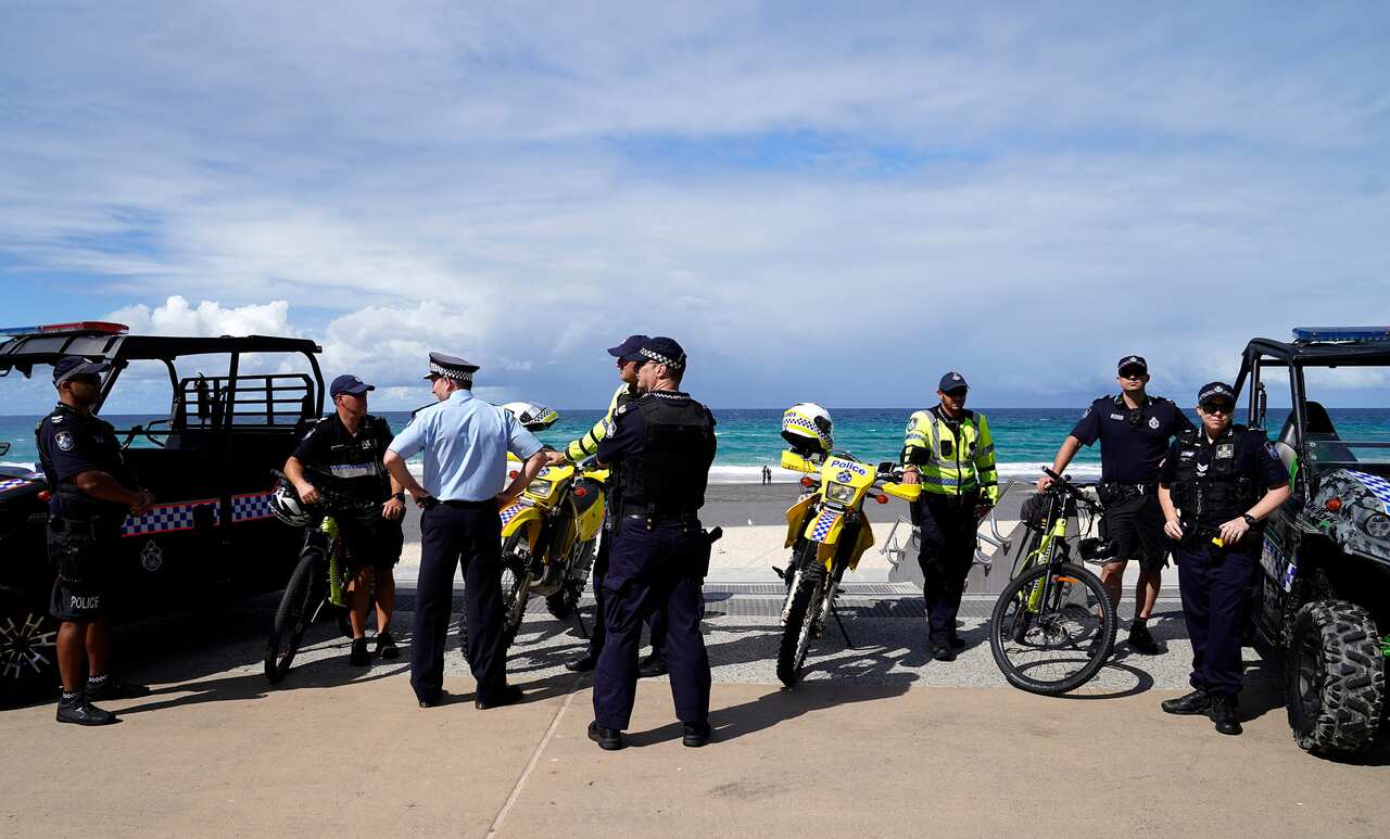 Queensland police enforce social distancing measures at Surfers Paradise on the Gold Coast.