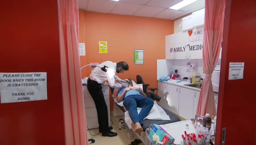 Dr Zia treats a patient in his consult room at iFamily Medical Centre in Rooty Hill.