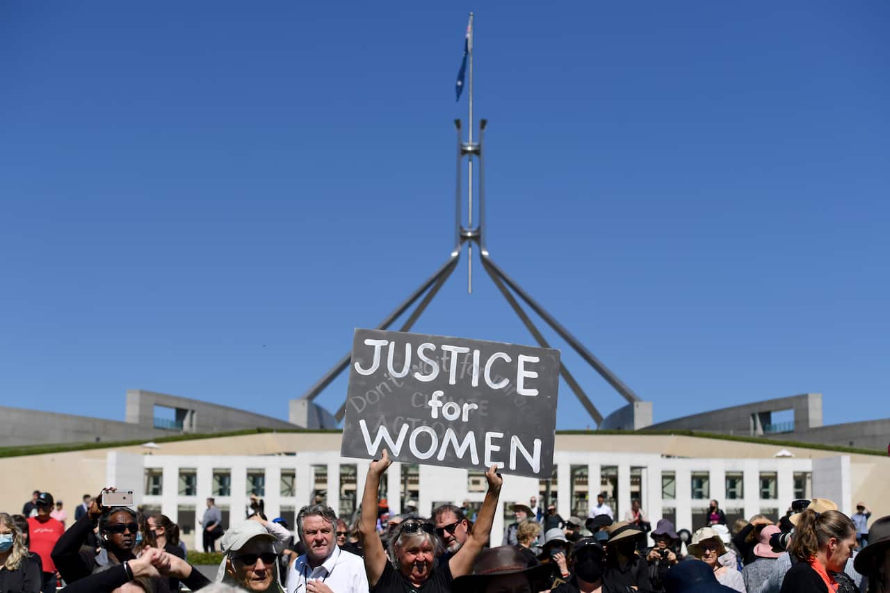 A protesters holds a placard during the Women's March 4 Justice in Canberra on Monday.