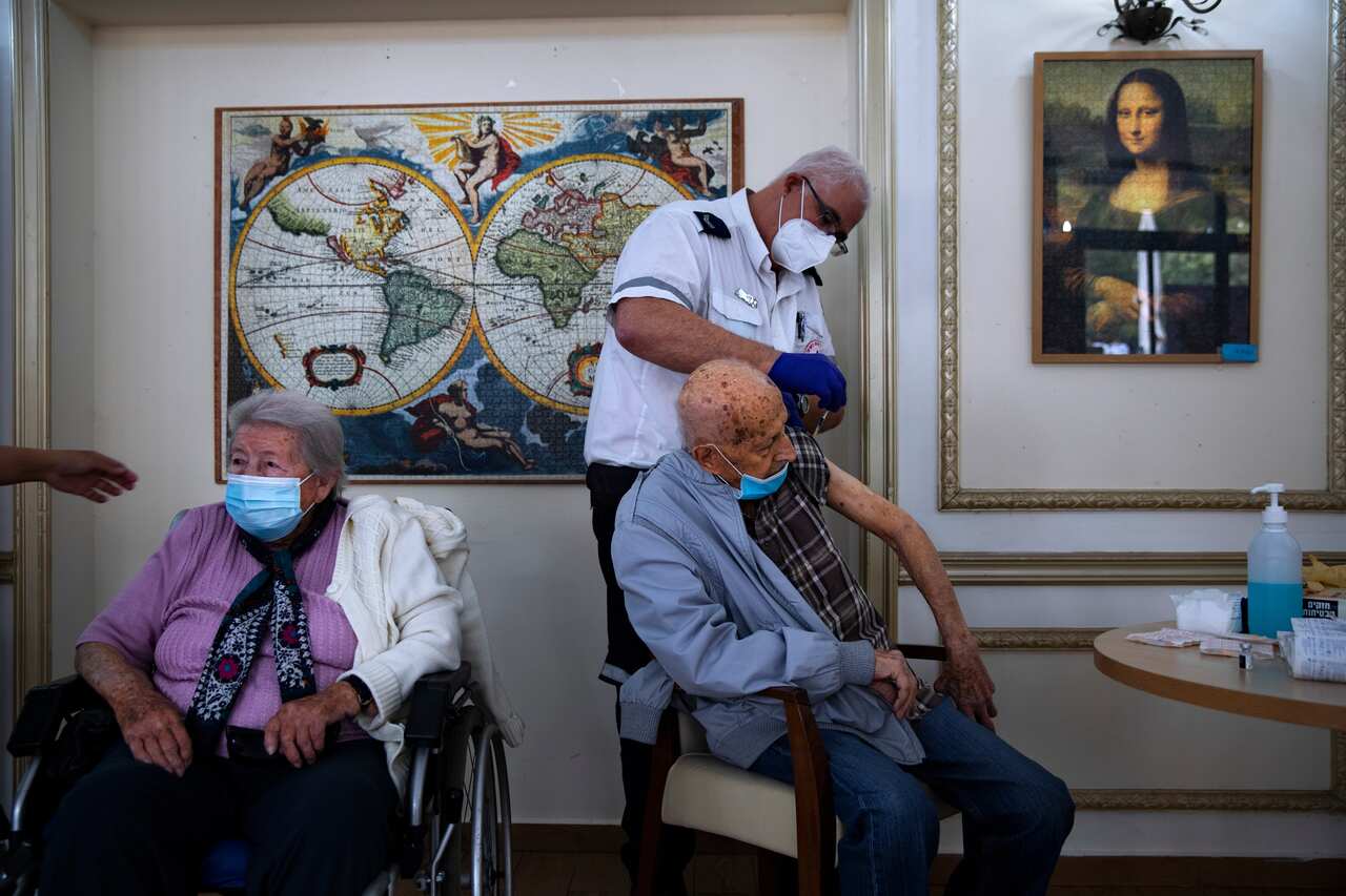 An elderly man receives COVID-19 vaccine at a private nursing home, in Ramat Gan, Israel. 