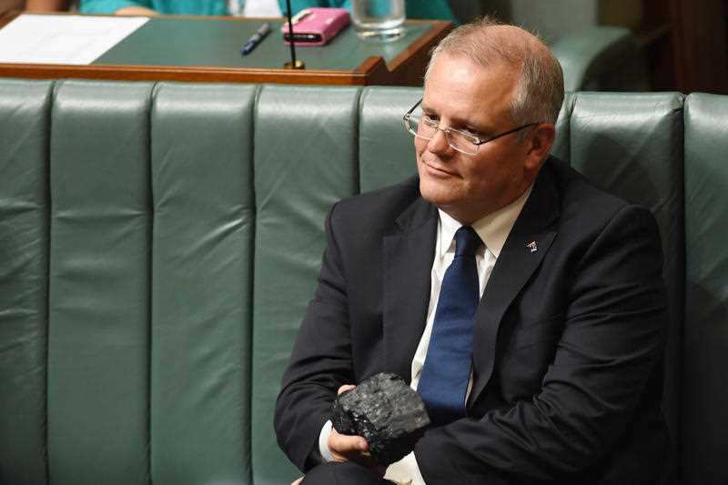 Scott Morrison holds a piece of coal during Question Time.