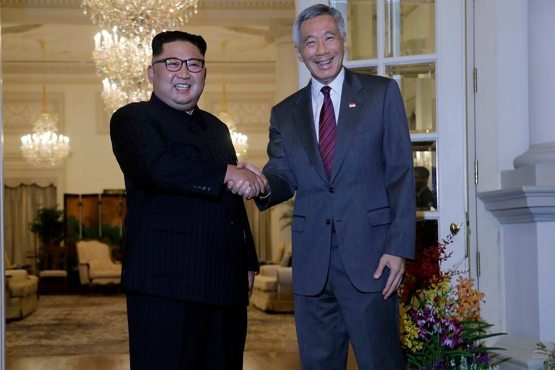 North Korean leader Kim Jong-un meets with Singapore's Prime Minister Lee Hsien Loong at the presidential palace.