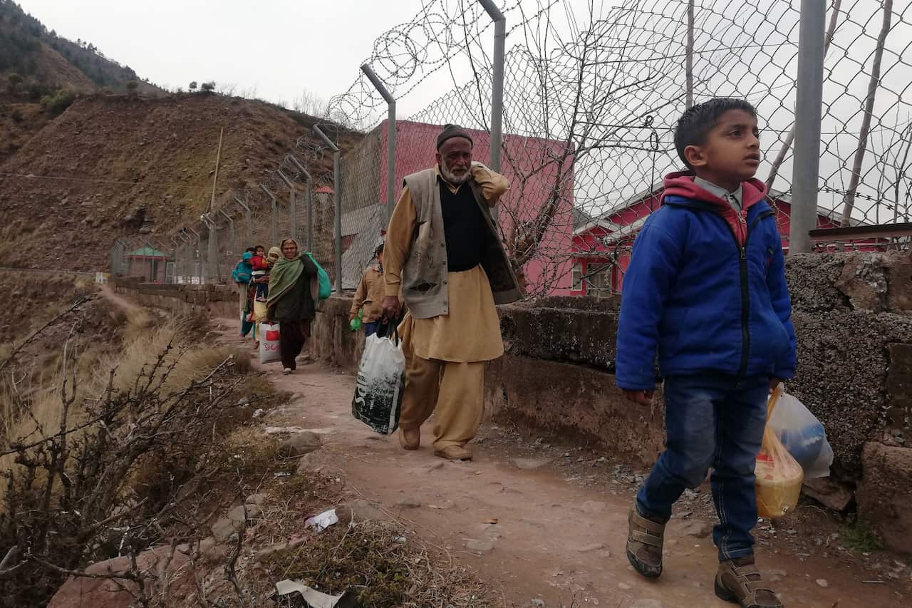 Locals fleeing their villages near the Line of Control, the de facto border between Pakistani- and Indian-administered Kashmir, in Chakothi, Pakistan