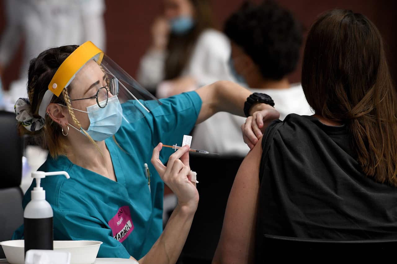 Members of the Indigenous community are seen receiving a Covid-19 vaccine at a pop-up vaccination clinic at the National Centre of Indigenous Excellence in Redfern, Sydney, Saturday, September 4, 2021. (AAP Image/Dan Himbrechts) NO ARCHIVING