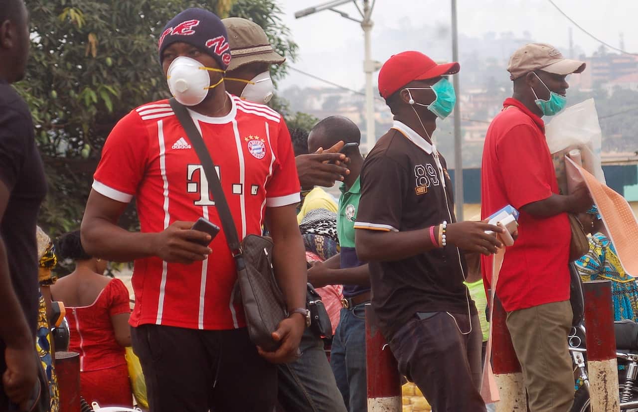 Hawkers wear face masks in Yaounde, Cameroon 18 March 2020.