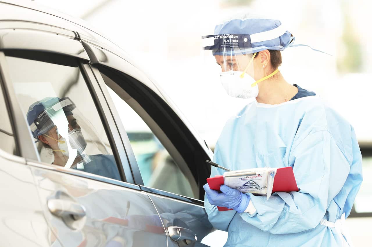 Healthcare workers administer COVID-19 tests at the Bondi Beach drive-through testing center on Monday.