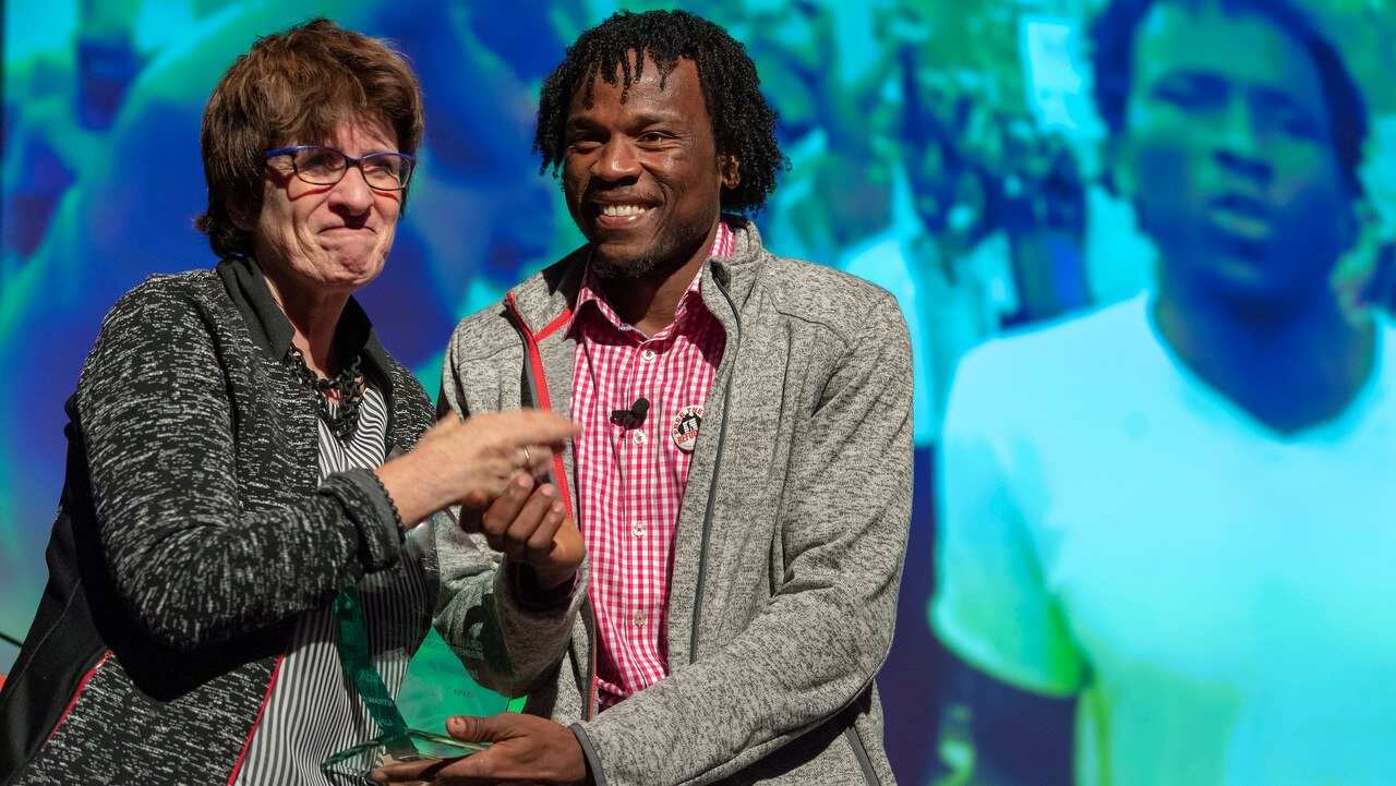 UN Deputy High Commissioner for Human Rights Kate Gilmore (L), and Prize winner, Sudanese Abdul Aziz Muhama, poses with his award.