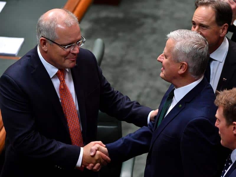 Prime Minister Scott Morrison is congratulated by colleagues.