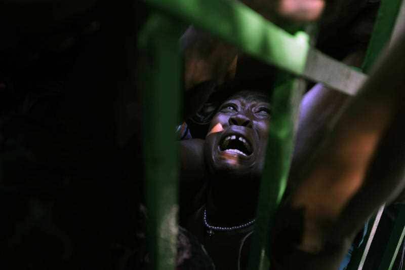 A woman is crushed in a crowd of people waiting for food rations in the aftermath of the Jan. 12 earthquake in Port-au-Prince, Haiti in 2010