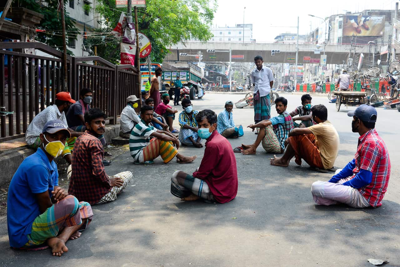 Police detain rickshaw pullers on the street during a nationwide lockdown in Bangladesh.