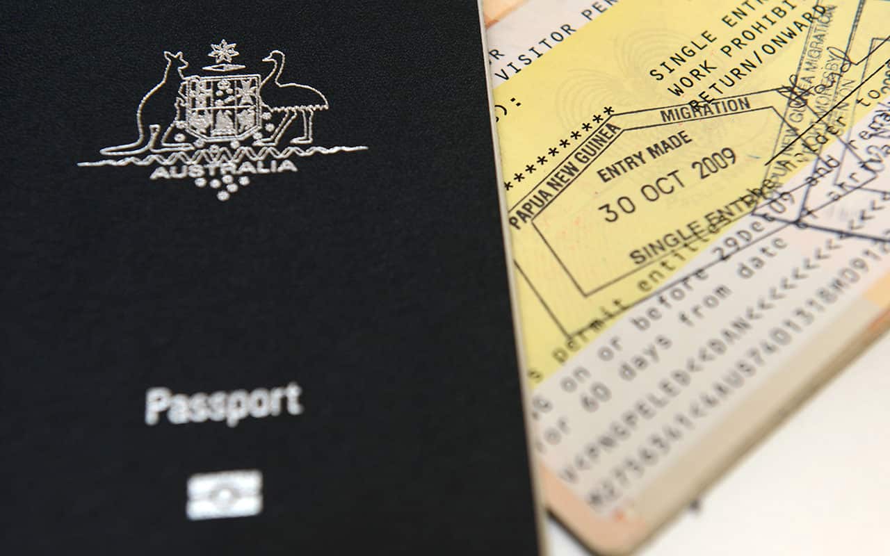 An Australian passport is pictured next to an entry visa to Papua New Guinea in Brisbane.