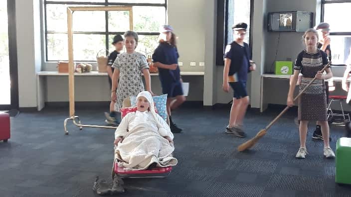 At the play rehearsals. 