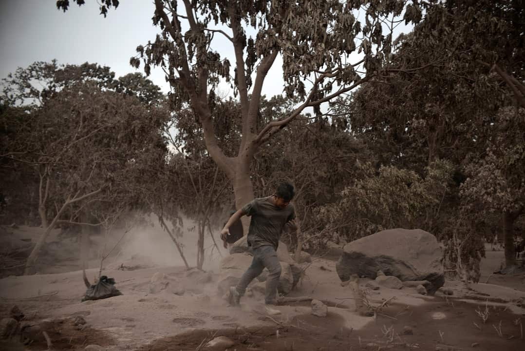 A man runs as a new wave of lava hits the community of San Miguel Los Lotes in Escuintla, Guatemala.