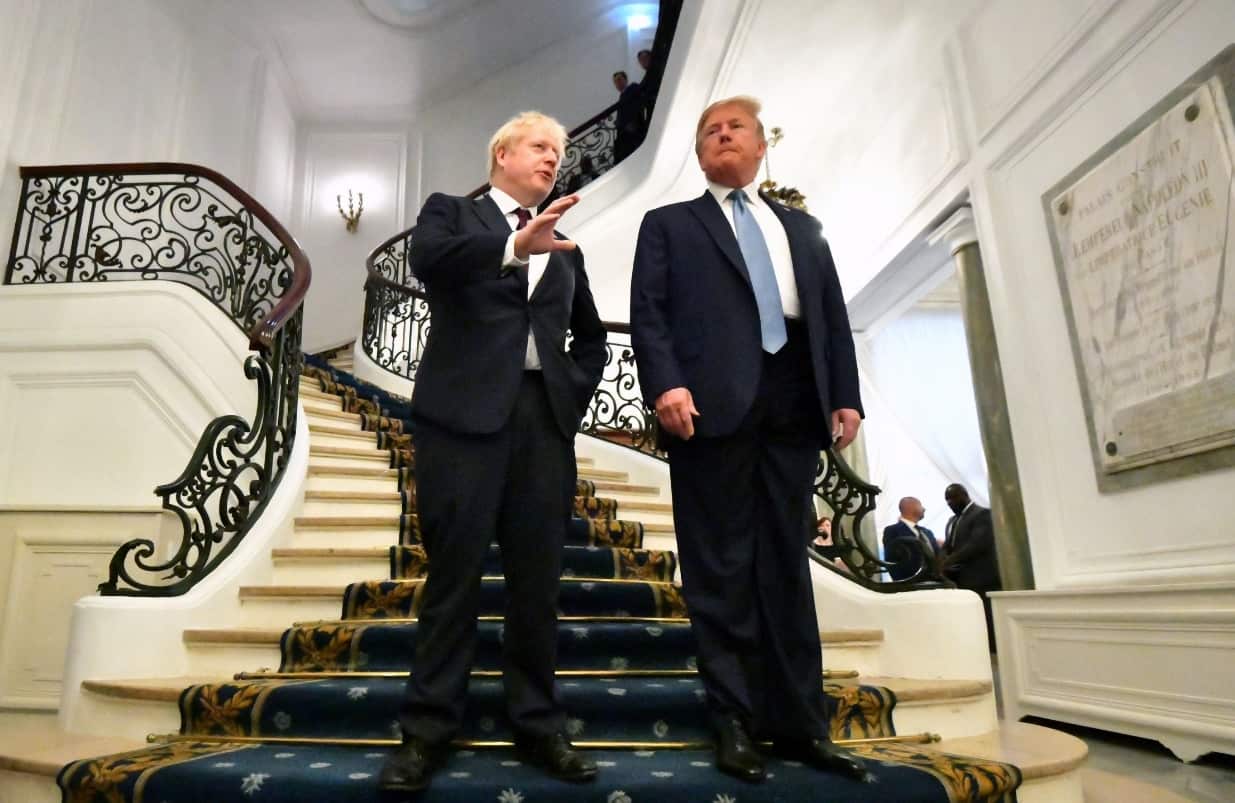 US President Donald J. Trump (R) and Britain's Prime Minister Boris Johnson (L) pose as they arrive for a bilateral meeting during the G7 summit in Biarritz