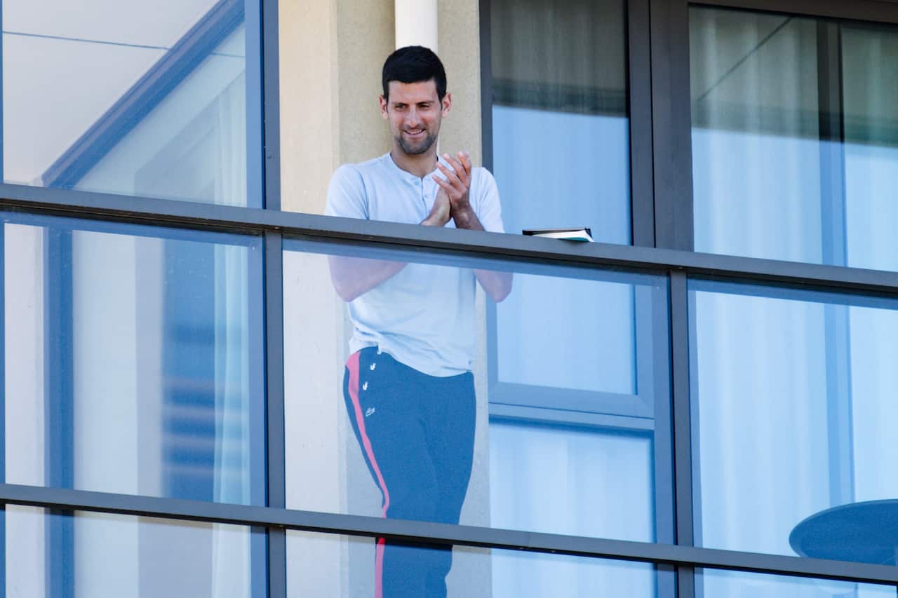 Tennis star Novak Djokovic is seen on the balcony of hotel quarantine accommodation in North Adelaide