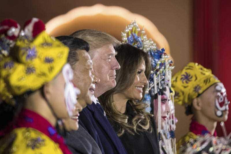 President Donald Trump, center, and first lady Melania Trump, center right, pose for a photograph with Chinese President Xi Jinping, center left