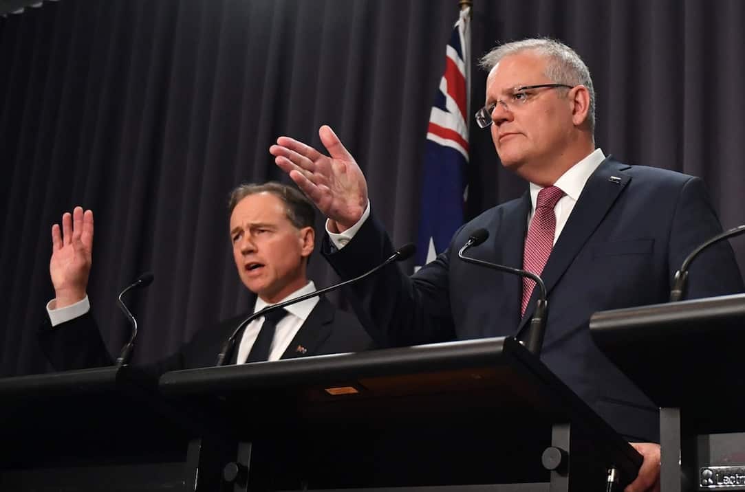 Health Minister Greg Hunt and Prime Minister Scott Morrison talk to reporters.