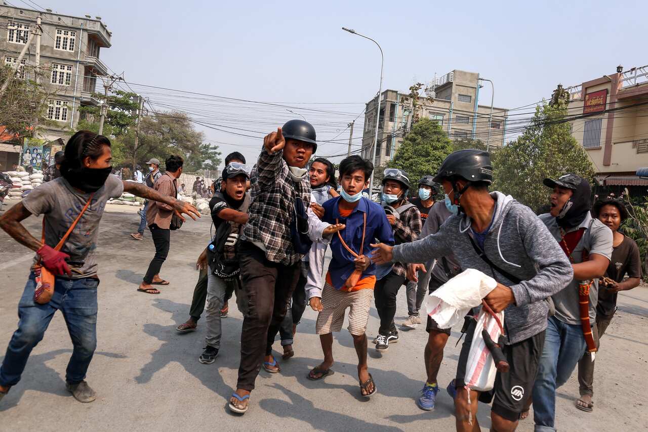 People carry an injured demonstrator during a protest against the military coup in Mandalay, Myanmar, on 22 March.