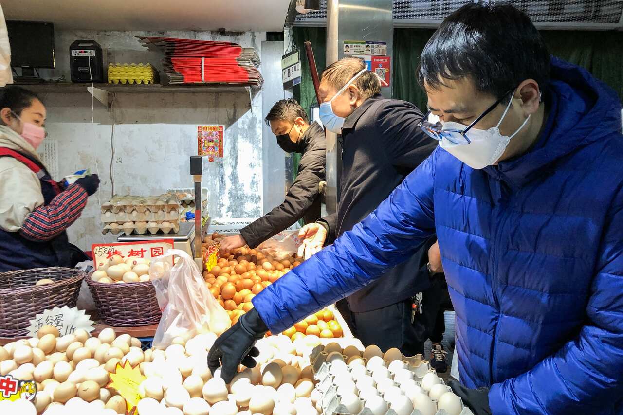 BEIJING, CHINA - FEBRUARY 17, 2020: People in face masks shop for eggs at Shengfu Xiaoguan Market. Zoya Rusinova/TASS/Sipa USA