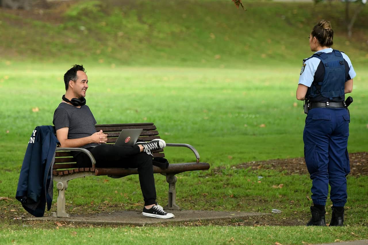 NSW Police officers ask people to move on at a park in Sydney. 