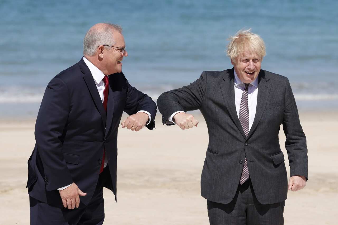 Prime Minister Boris Johnson greets Australian Prime Minister Scott Morrison during the G7 summit in Cornwall.  