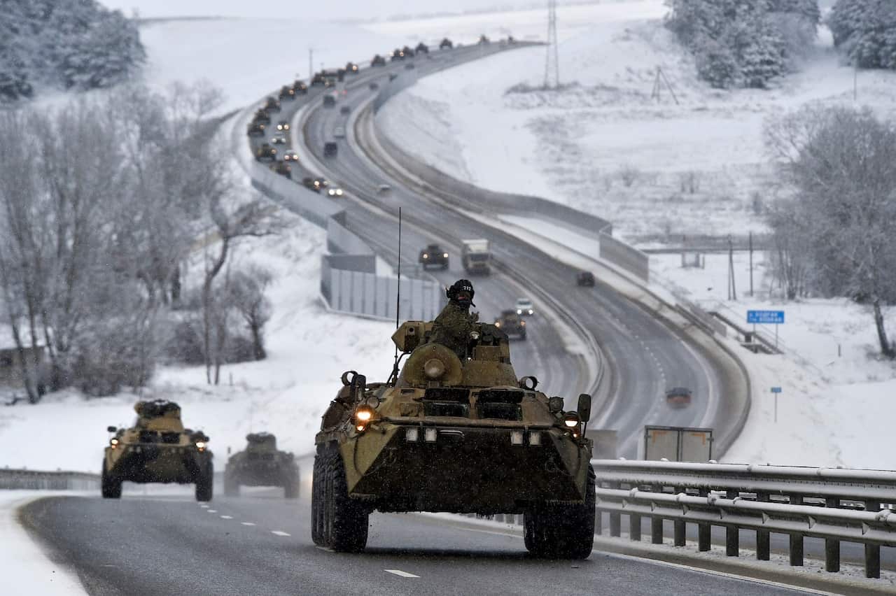 A convoy of Russian vehicles moves along a highway in Crimea.