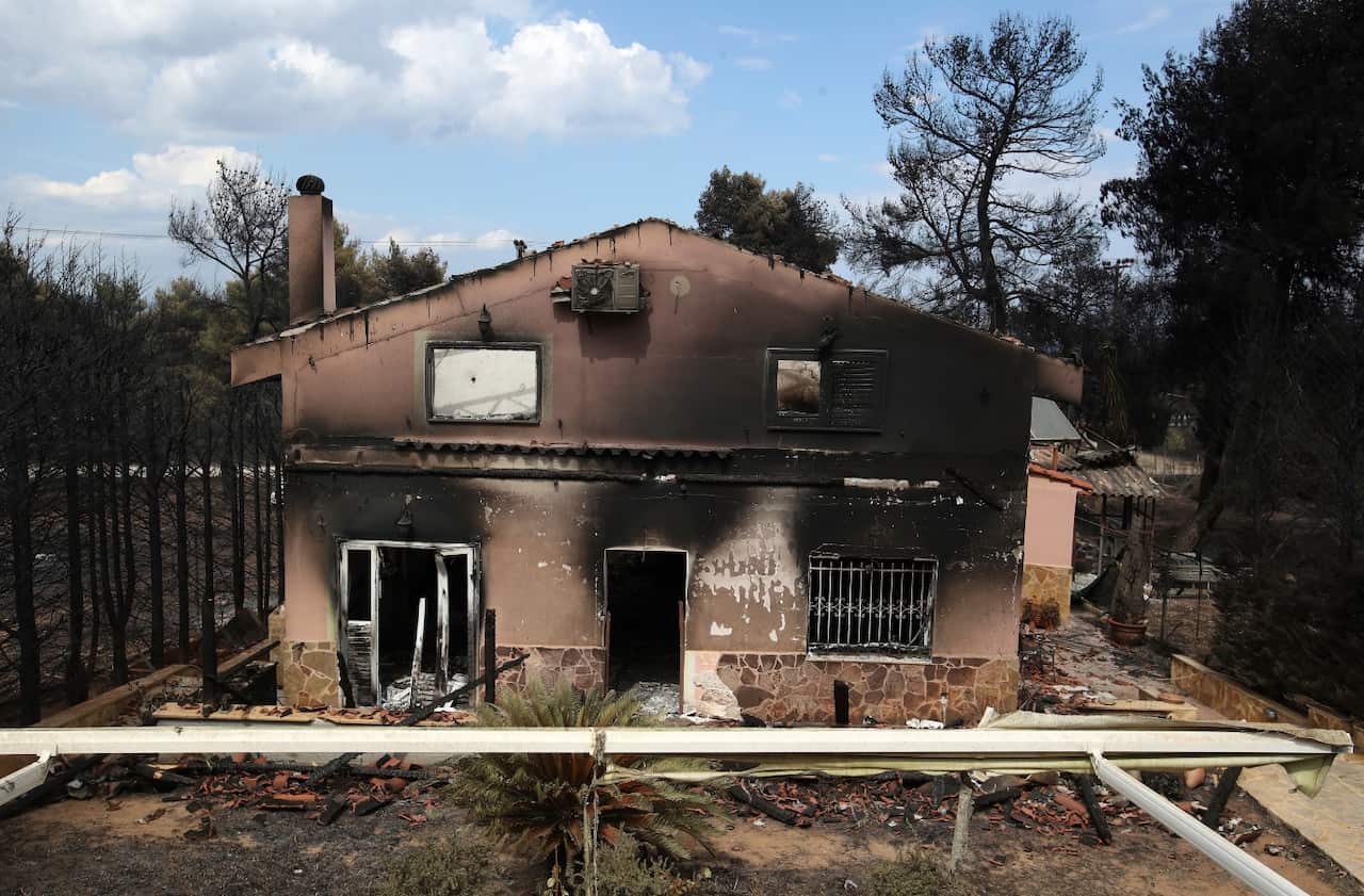 A burned house is seen in Agios Andreas, east of Athens, Tuesday, July 24, 2018.