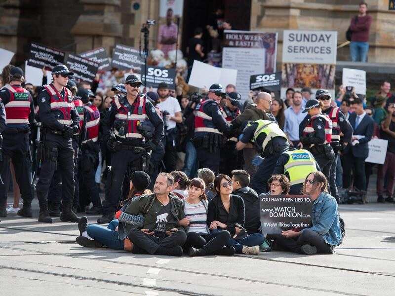 Animal rights protesters were arrested after blocking a major Melbourne CBD intersection.