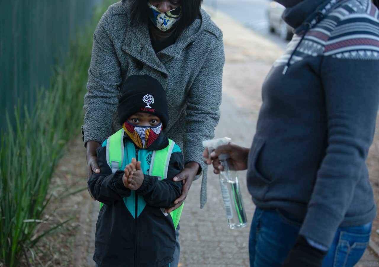 A pupil has his hands sanitised, as students returned to the classroom this month.
