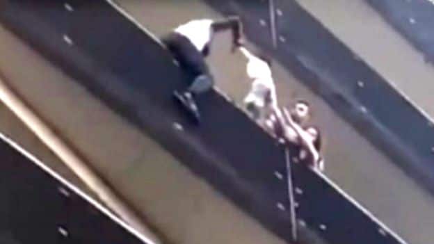 Once at the fourth floor Mr Gassama pulls the child to safety