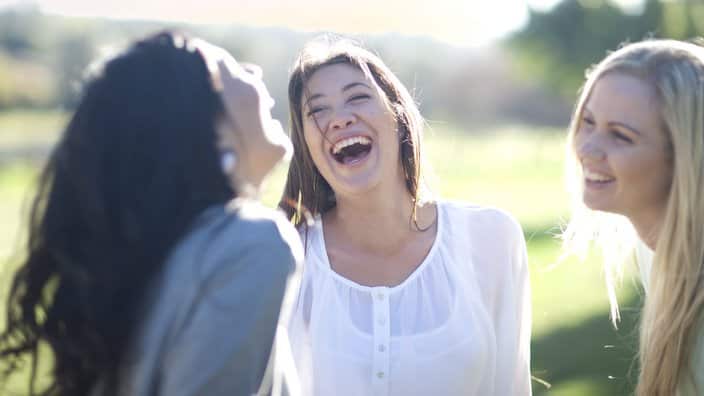 Three young women having fun in park