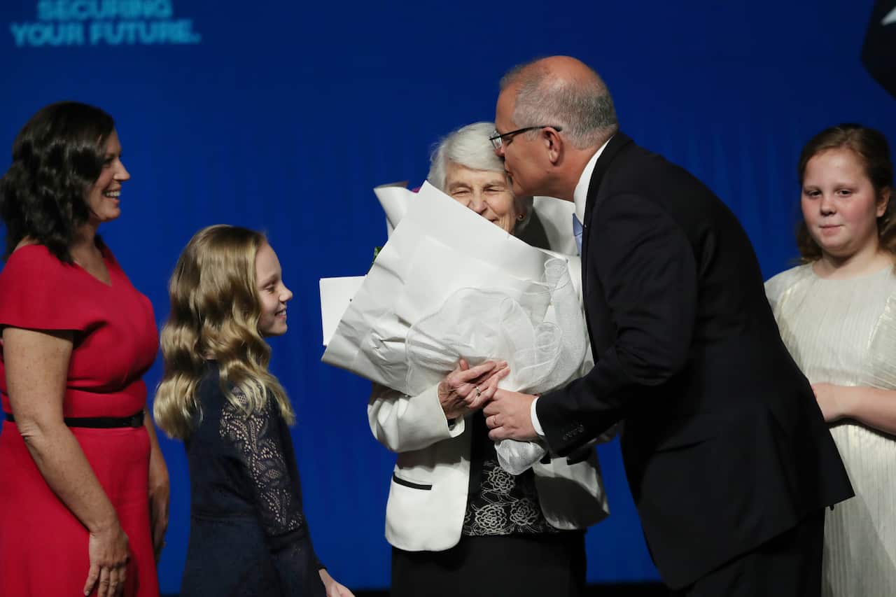 Prime Minister Scott Morrison hands over flowers for mothers day with his wife Jenny (left), mother Marion (centre) and two daughters Abbey ( second left), and lily (right) during the Liberal Party campaign launch.