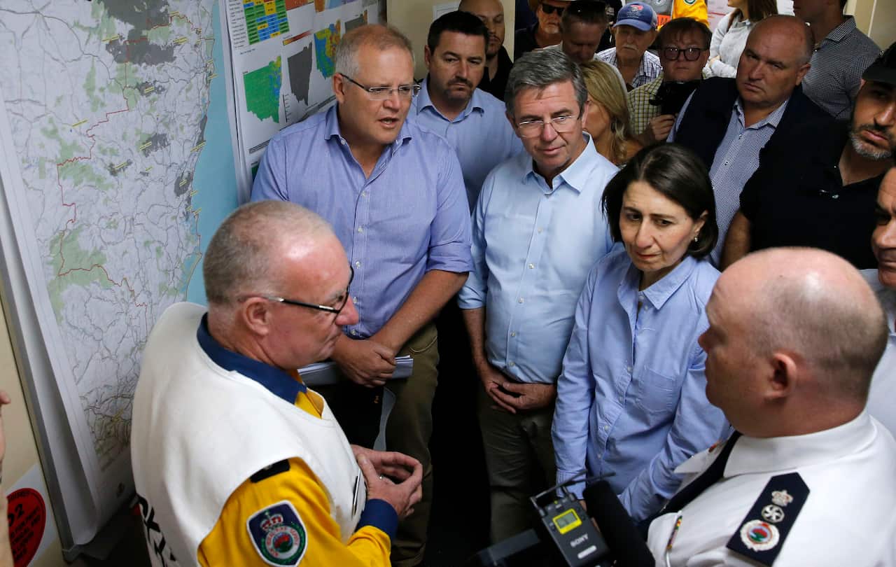 Prime Minister Scott Morrison and NSW Premier Gladys Berejiklian are briefed on the fires at Mid North Coast Fire Control Centre in Wauchope, New South Wales, Sunday, November 10, 2019. (AAP Image/Darren Pateman) NO ARCHIVING