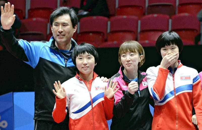Members of North Korea and South Korea table tennis teams pose for a photograph after deciding to combine their teams