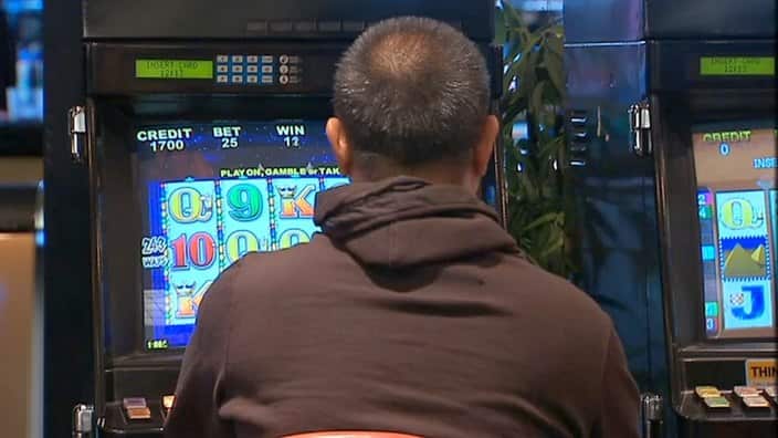 A man playing a poker machine