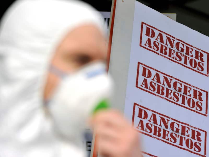 Protesters wearing protective asbestos equipment