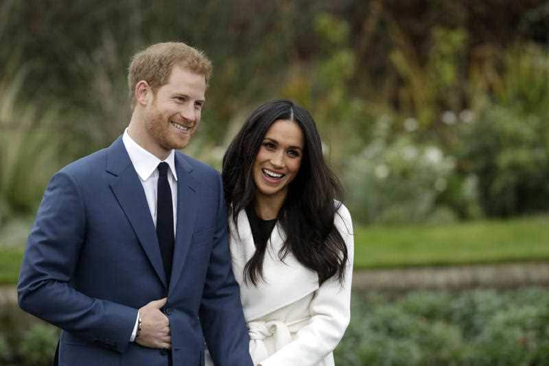 Britain's Prince Harry and his fiancee Meghan Markle pose for photographers during a photocall in the grounds of Kensington Palace in London, Monday Nov. 27, 2017.