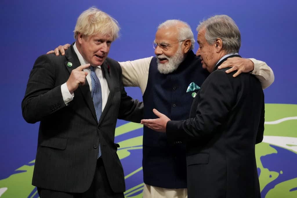 British PM Boris Johnson (L) and UN Secretary-General Antonio Guterres (R) greet Indian Prime Minister Narendra Modi as they arrive for day two of COP26.