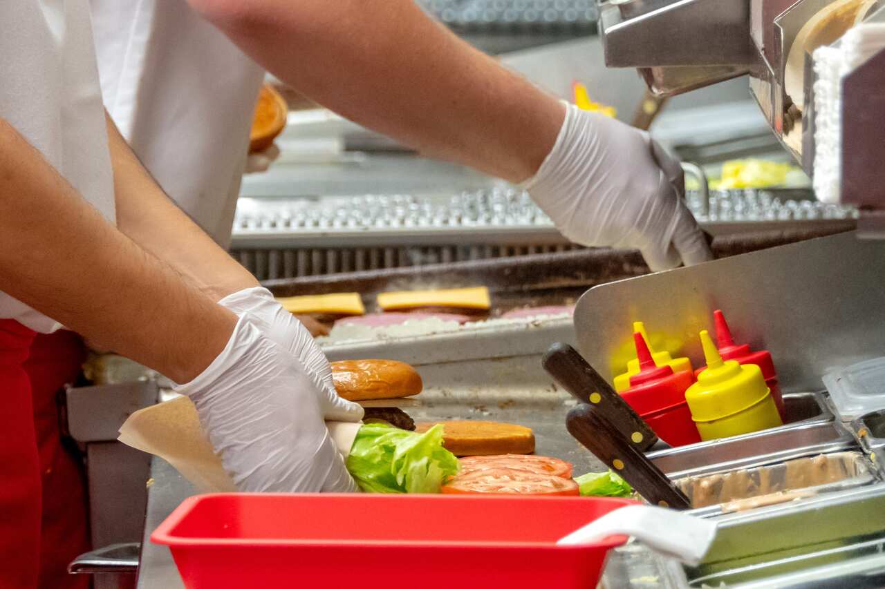 Fast food workers working in a hamburger restaurant.