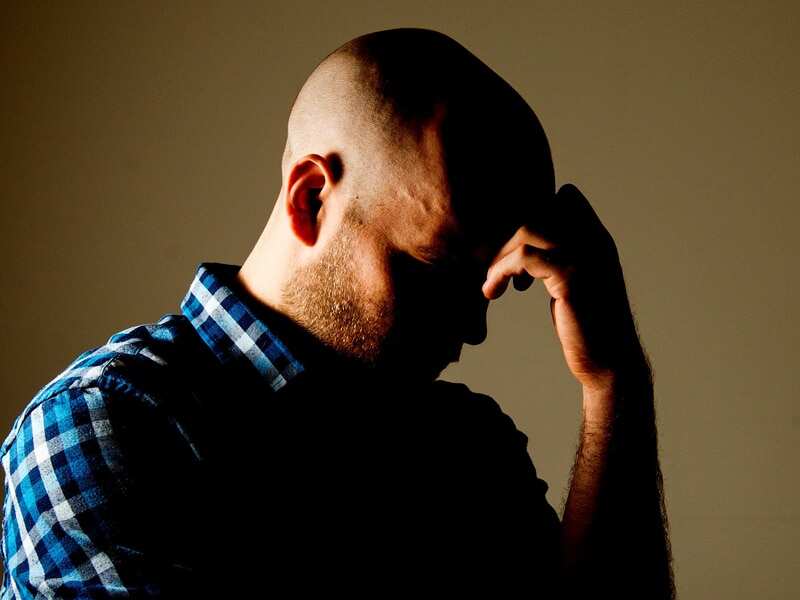 a man with his hand on his head