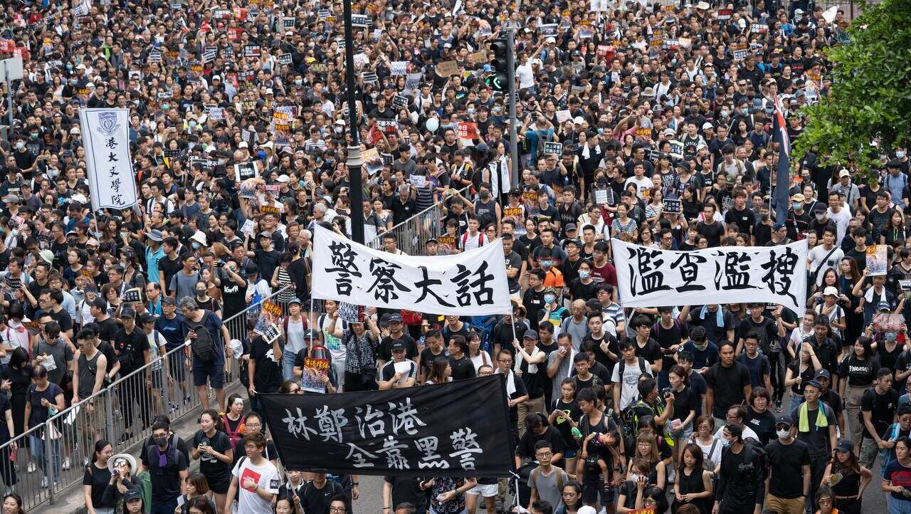Protesters march to the West Kowloon High Speed Railway Station to demand the Hong Kong government to withdraw the extradition bill.