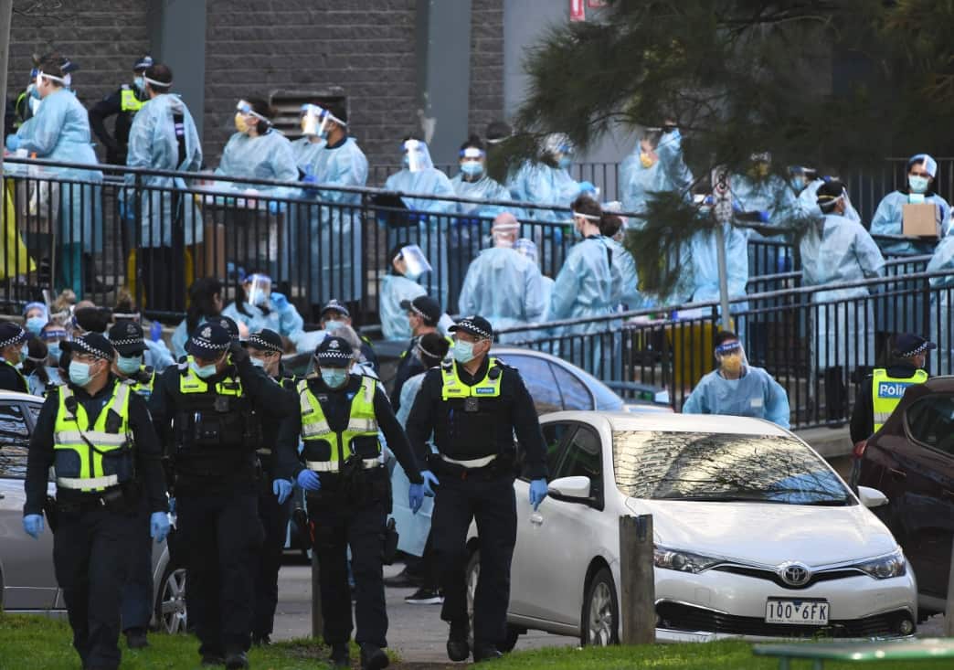 Victorian health officials work to conduct testing during a lockdown of a Melbourne public housing tower. 