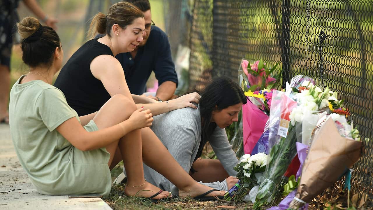 Mother Leila Geagea (right) places flowers at the memorial for her children killed in a car crash in the Sydney suburb of Oatlands.