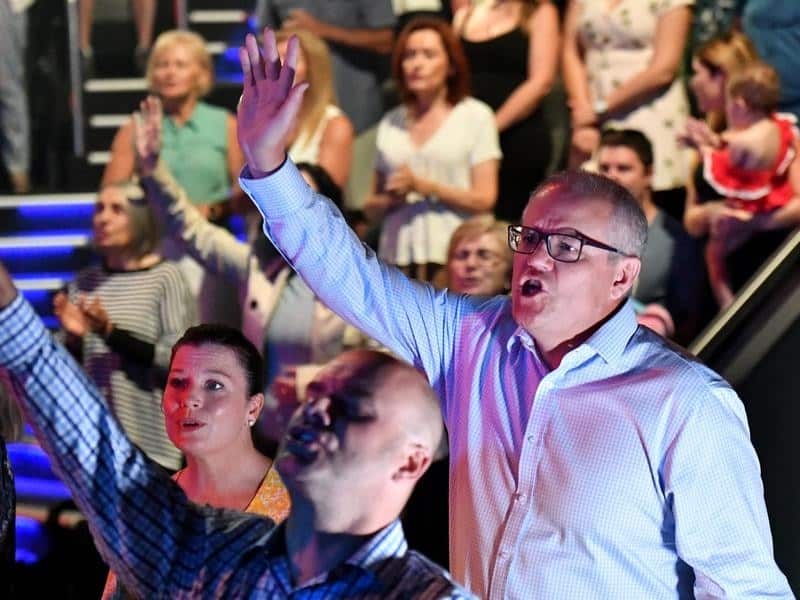 Scott Morrison and wife Jenny sing during an Easter Sunday service at their church in Sydney. The PM has always been open about his faith. 