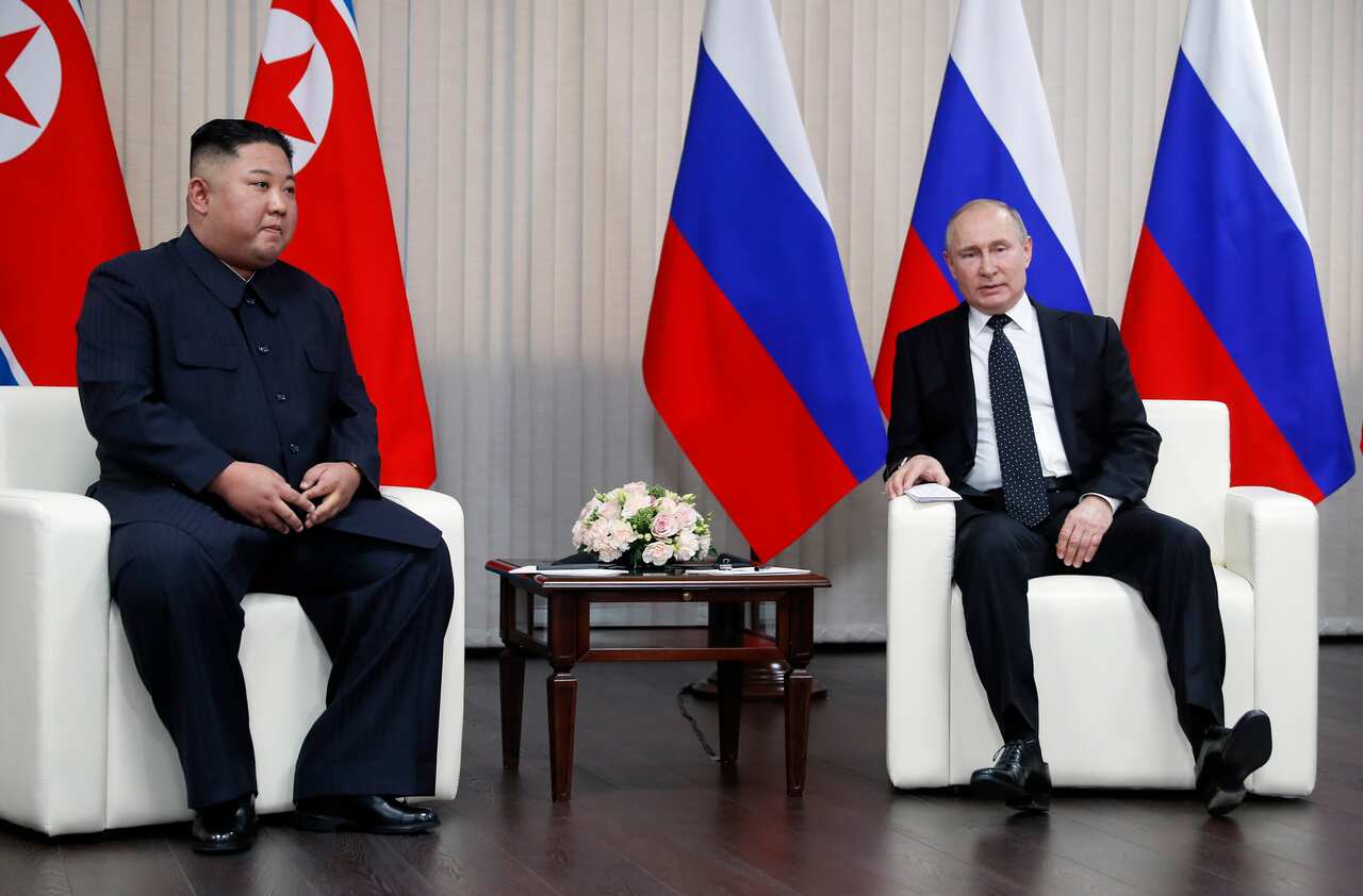 Vladimir Putin speaks with Kim Jong-un during their meeting at the Far East Federal University.