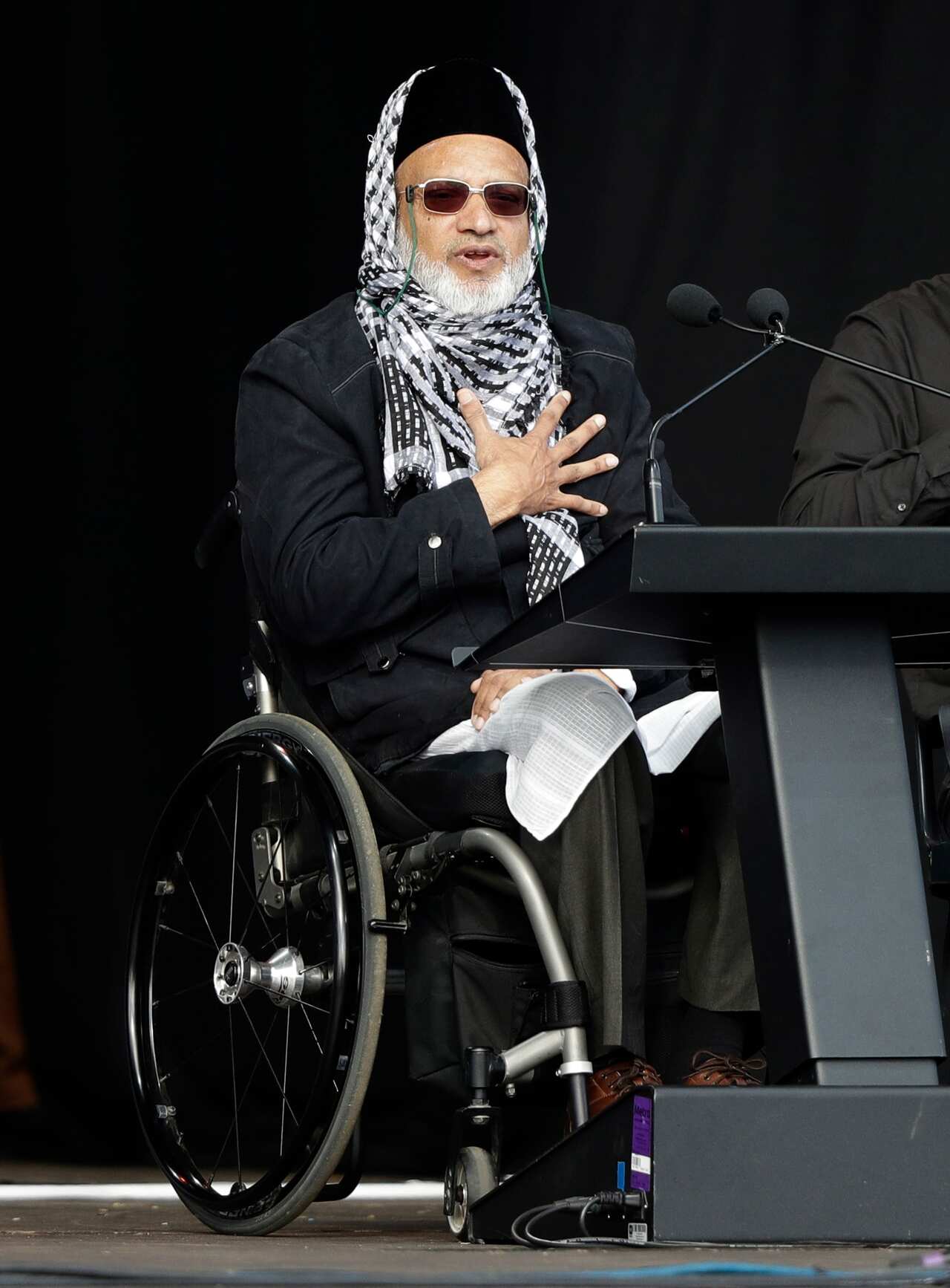 Mosque shooting survivor Farid Ahmed addresses the national remembrance service in Hagley Park for the victims of the March 15 mosques terrorist attack in Christchurch, New Zealand, Friday, March 29, 2019. (AP Photo/Mark Baker)