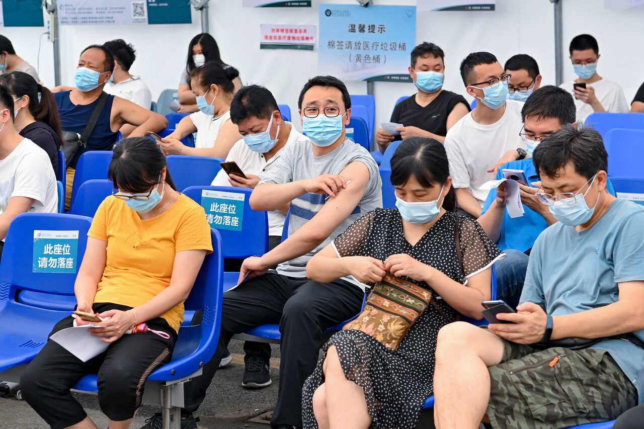 Local residents sit in an observation area after receiving a dose of the COVID-19 vaccine at Guangdong Second Provincial General Hospital.