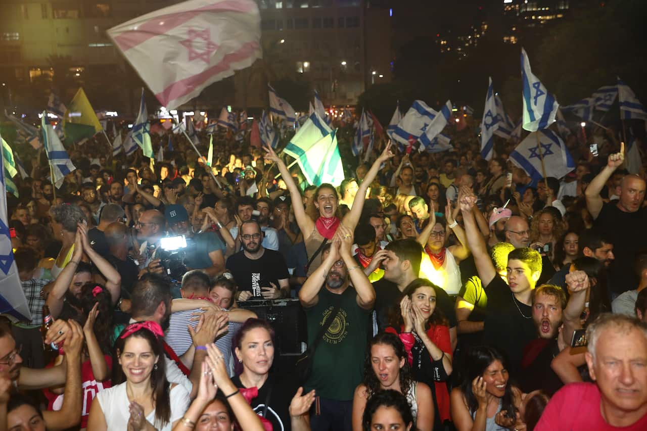 Israelis celebrate the swearing in of the new government in Tel Aviv, Israel, Sunday, 13 June, 2021. 