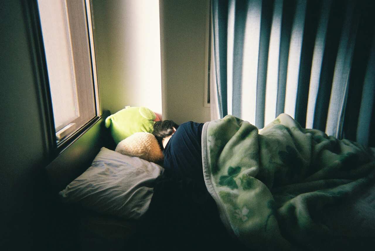 A person sleeping on the bed.