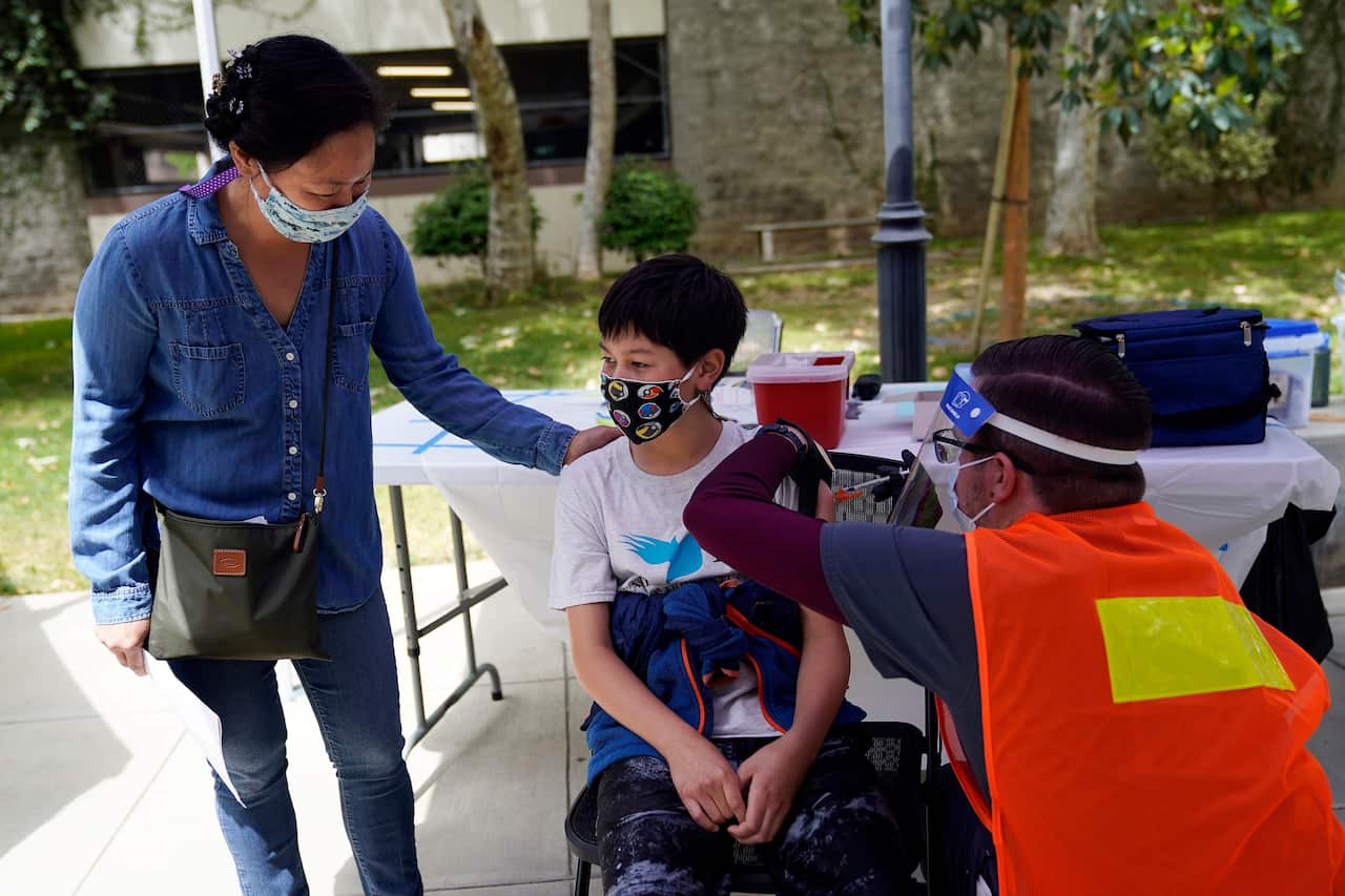 A 12-year-old boy receives a Pfizer vaccine in California. Pfizer vaccines could soon be available for children aged 5 to 11.